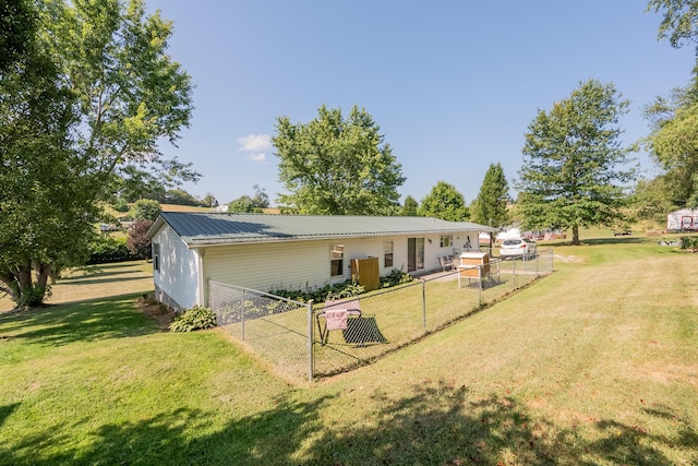 rear view of house with a lawn