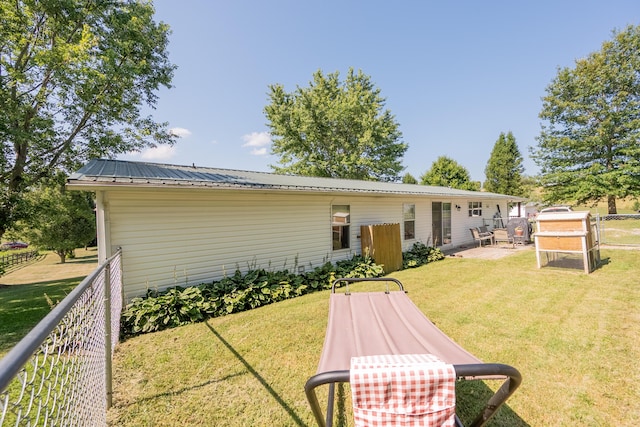 rear view of house featuring a lawn