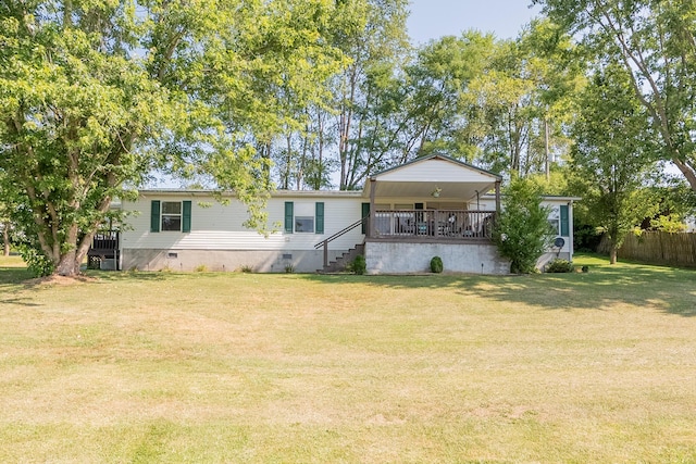 back of house featuring a deck and a lawn