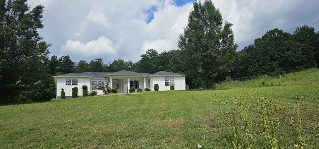 ranch-style home featuring a front yard