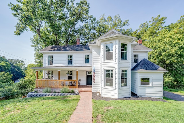 view of property featuring a front lawn and a porch