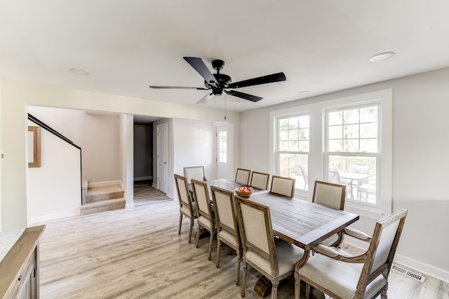 dining area with ceiling fan and light hardwood / wood-style floors