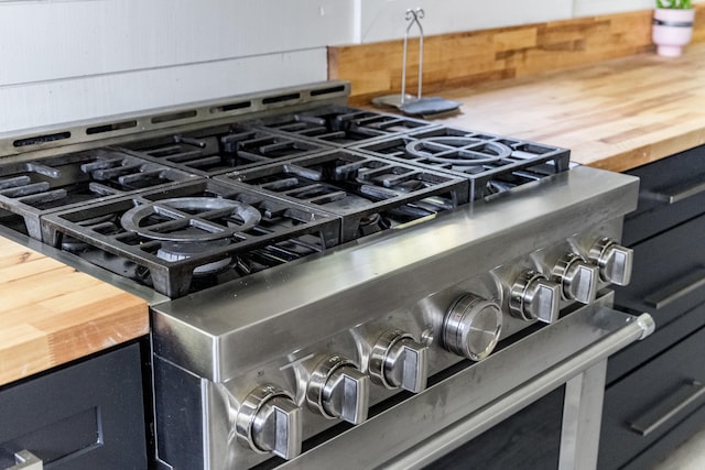 interior details featuring wooden counters and stainless steel stove