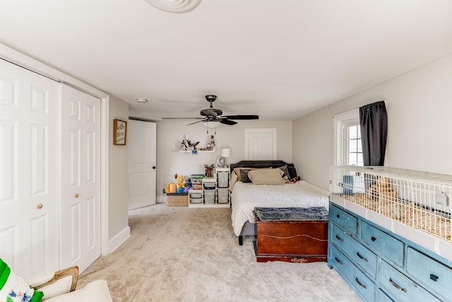 bedroom with light carpet, ceiling fan, and a closet