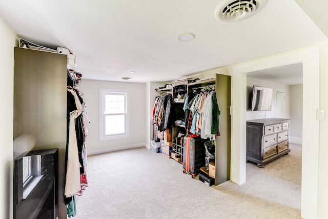 spacious closet featuring light carpet