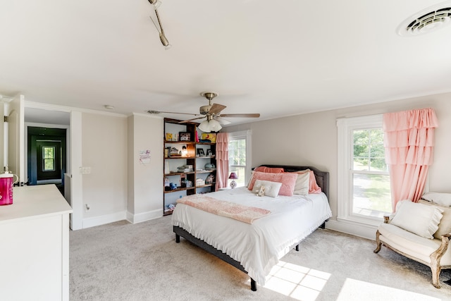 bedroom featuring crown molding, light colored carpet, and ceiling fan