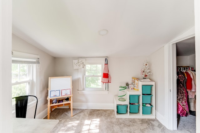 carpeted bedroom featuring vaulted ceiling and a closet