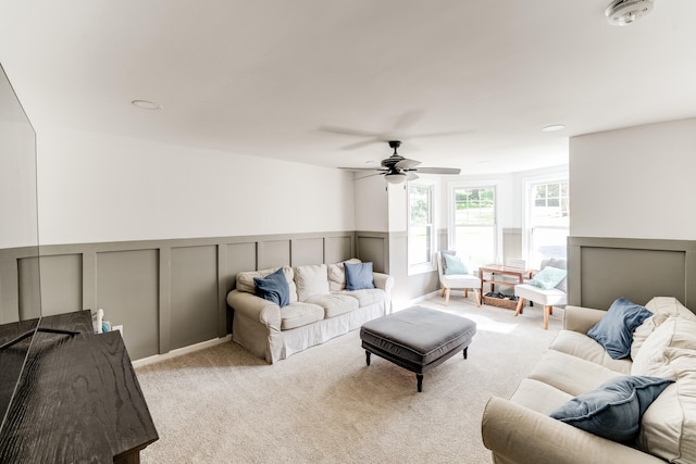 living room with light colored carpet and ceiling fan