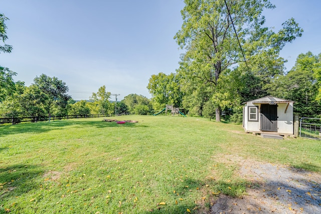 view of yard featuring a playground and a shed