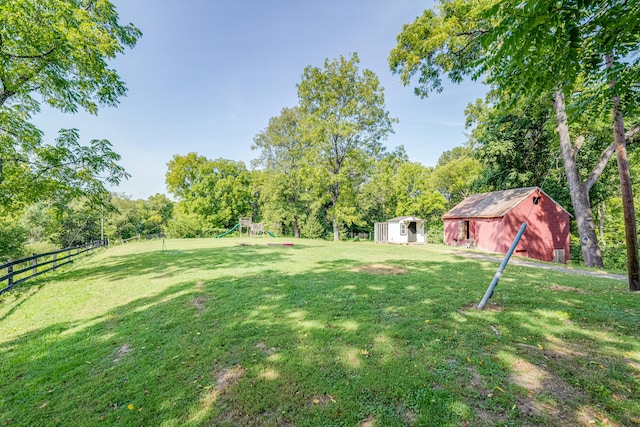 view of yard featuring a playground and a storage unit