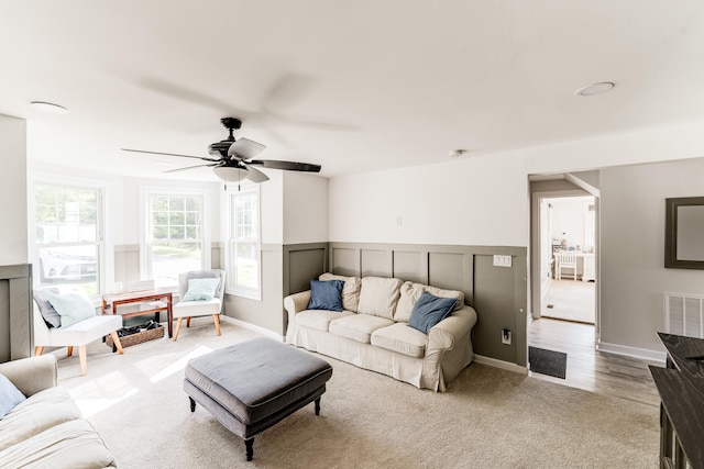 living room featuring light wood-type flooring and ceiling fan