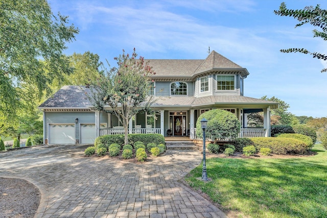 318 Egret Dr, Union Hall, VA 24176 - victorian house with a porch, a garage, decorative driveway, a front lawn, and roof with shingles