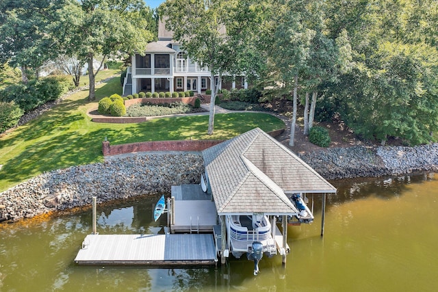 dock area featuring a lawn and a water view