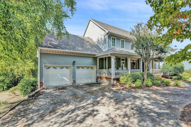 view of front of home featuring a garage and a porch