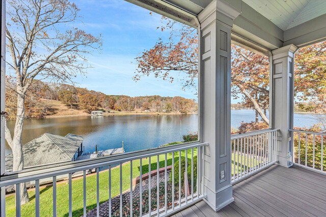 unfurnished sunroom featuring a water view