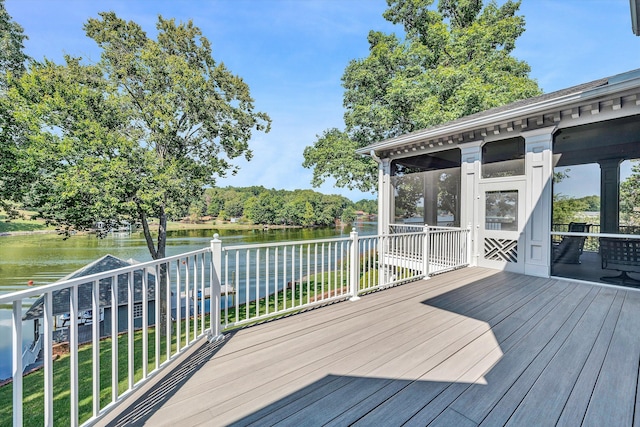 wooden deck with a sunroom and a water view