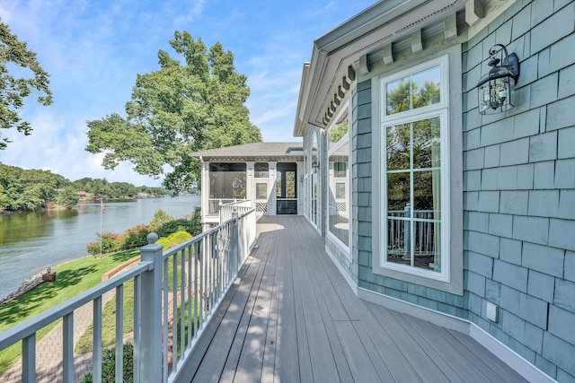 wooden terrace with a sunroom and a water view