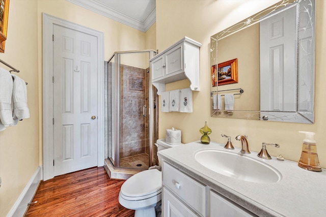 bathroom with crown molding, vanity, an enclosed shower, hardwood / wood-style floors, and toilet