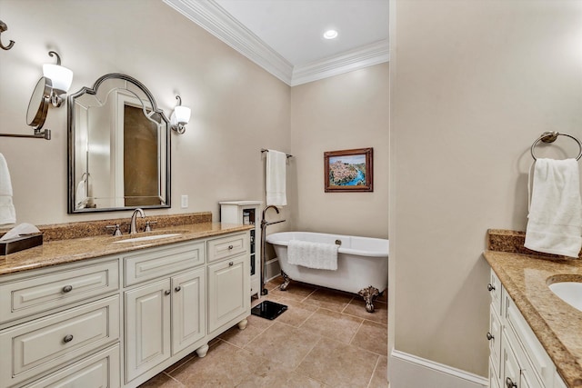 bathroom with a washtub, vanity, tile patterned flooring, and ornamental molding