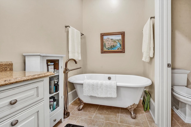 bathroom featuring toilet, a bath, tile patterned floors, and vanity