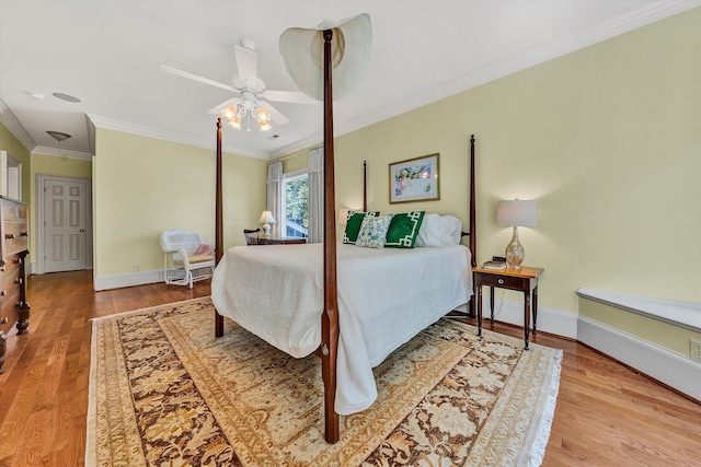 bedroom featuring hardwood / wood-style flooring, ornamental molding, and ceiling fan