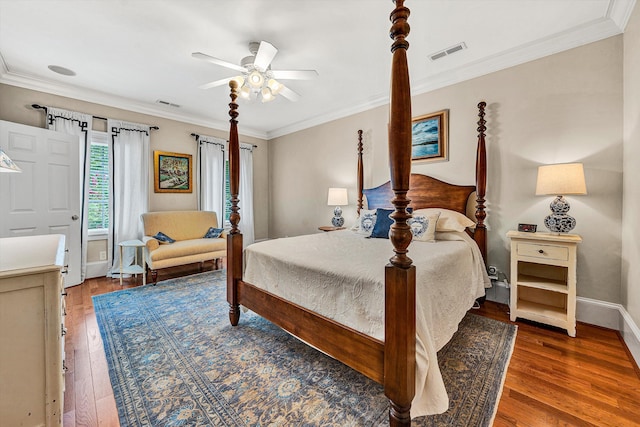 bedroom with ceiling fan, dark hardwood / wood-style floors, and crown molding