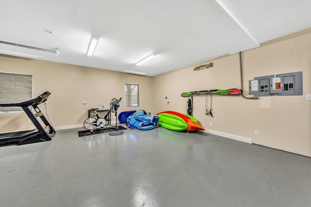 exercise area featuring electric panel and concrete floors