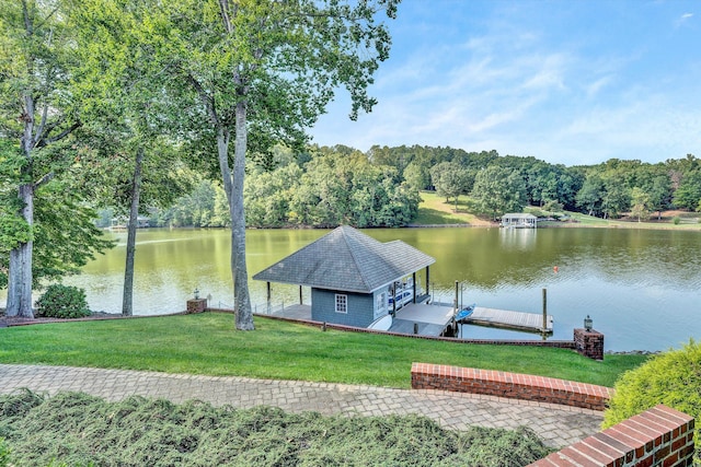 dock area with a water view and a yard