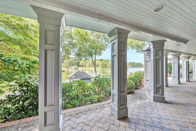 view of patio with a water view