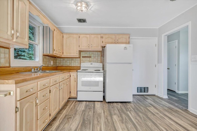 kitchen featuring light brown cabinetry, tasteful backsplash, white appliances, and light hardwood / wood-style floors