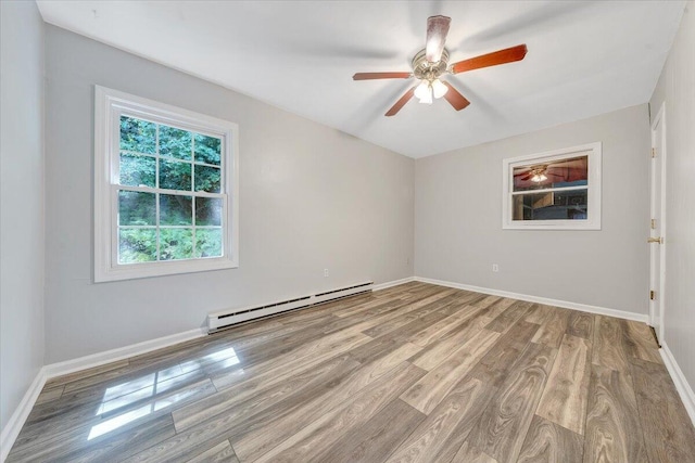 unfurnished room with a baseboard heating unit, ceiling fan, and light hardwood / wood-style floors