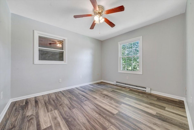 empty room featuring baseboard heating, wood-type flooring, and ceiling fan