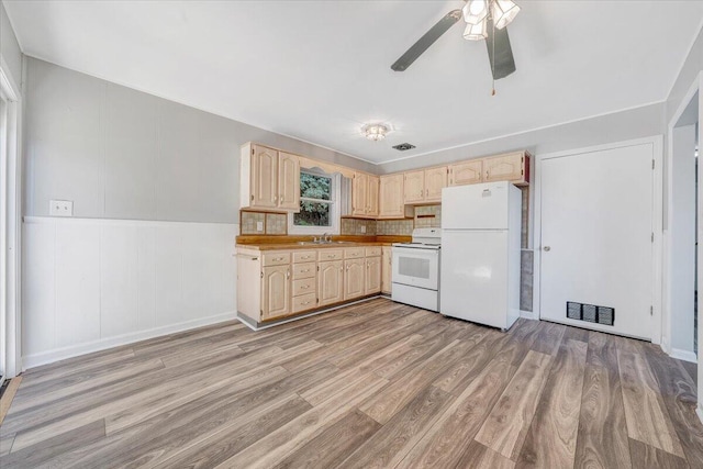 kitchen with white appliances, light hardwood / wood-style flooring, sink, ceiling fan, and light brown cabinets