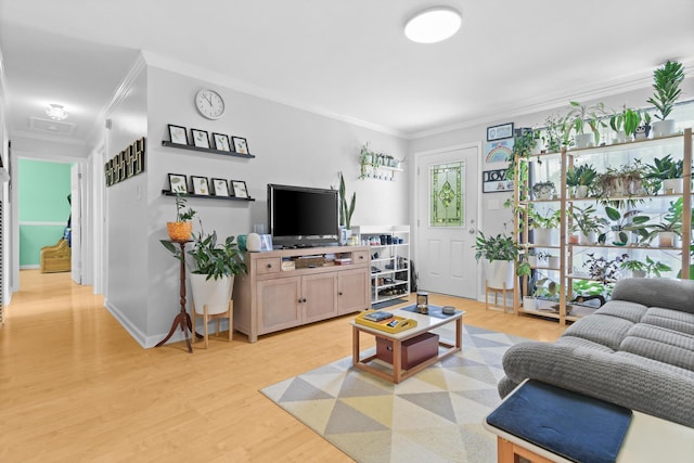 living room with light hardwood / wood-style floors and crown molding