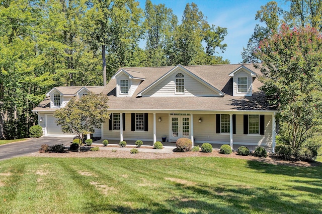 new england style home with french doors, a garage, and a front yard