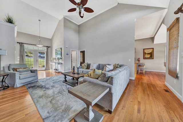 living room featuring high vaulted ceiling, ceiling fan, and light hardwood / wood-style flooring