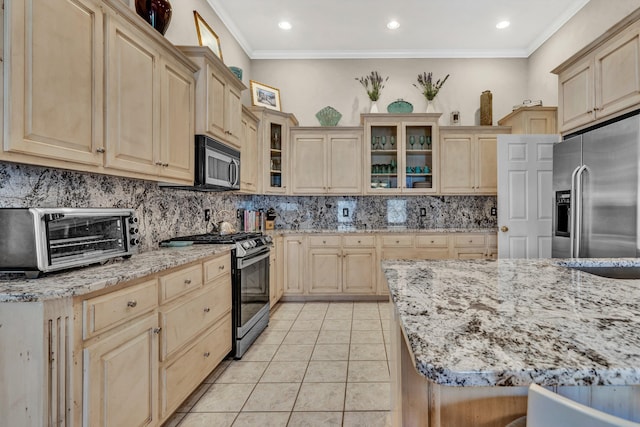 kitchen with crown molding, light tile patterned floors, stainless steel appliances, light brown cabinetry, and light stone counters