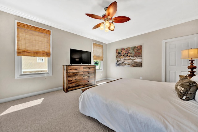 carpeted bedroom featuring crown molding, multiple windows, and ceiling fan