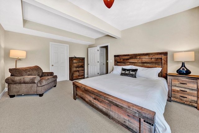 bedroom featuring light colored carpet and beamed ceiling