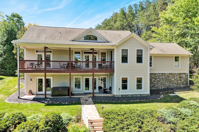 back of house featuring french doors, a patio area, a lawn, and ceiling fan