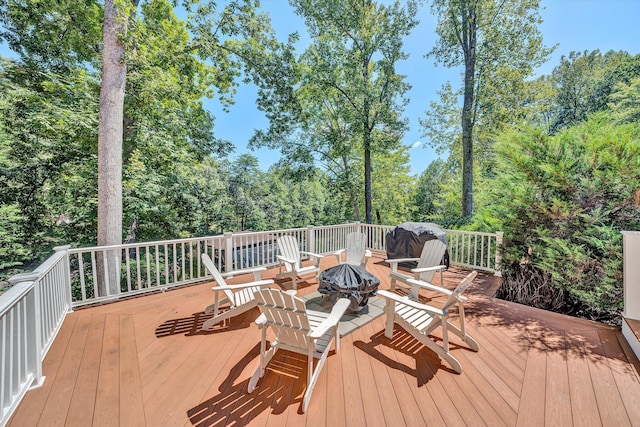 wooden deck with an outdoor fire pit