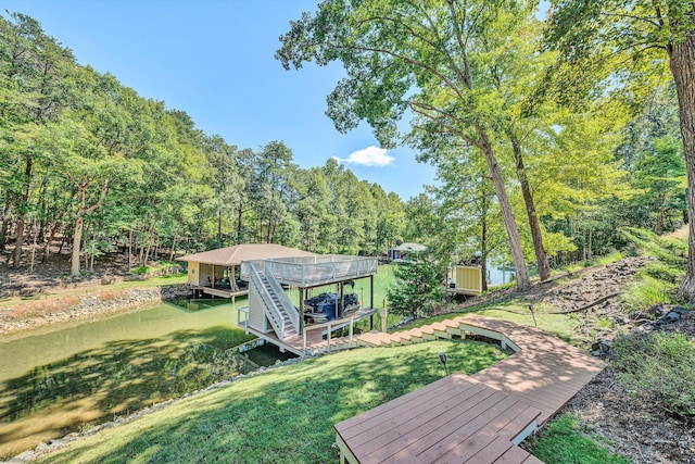 view of yard with a deck with water view