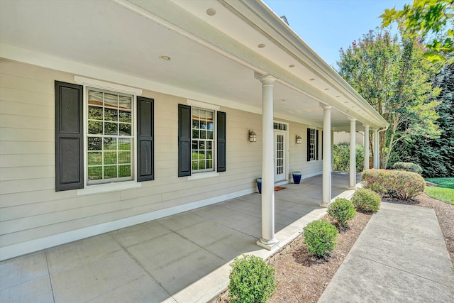 view of side of property with covered porch