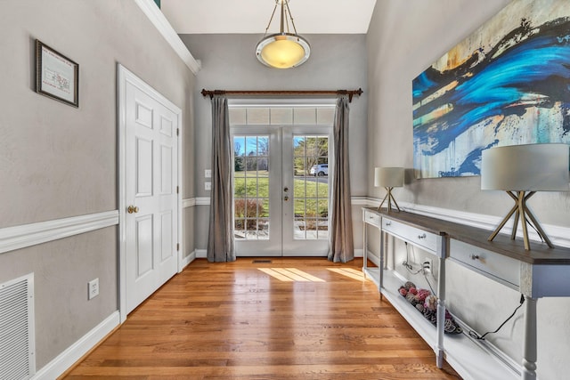 entrance foyer with hardwood / wood-style floors and french doors