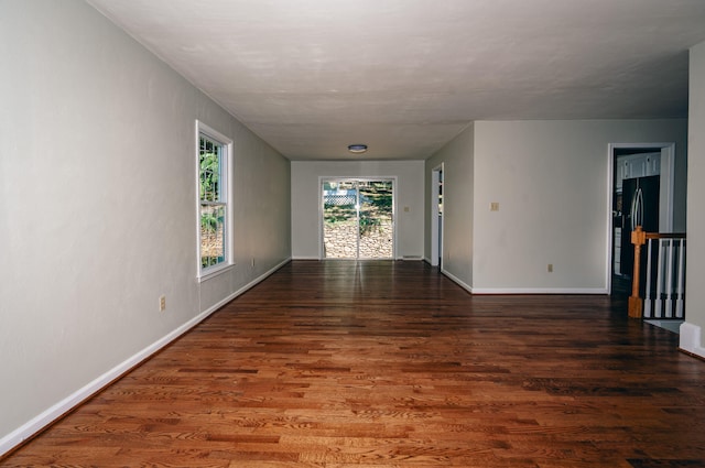 unfurnished room with dark hardwood / wood-style flooring