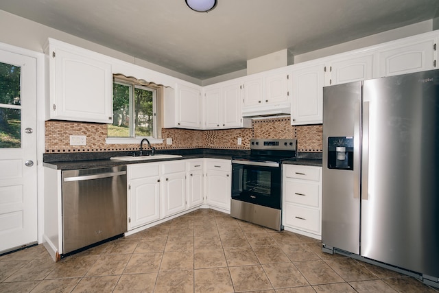 kitchen with sink, white cabinets, appliances with stainless steel finishes, and light tile patterned flooring