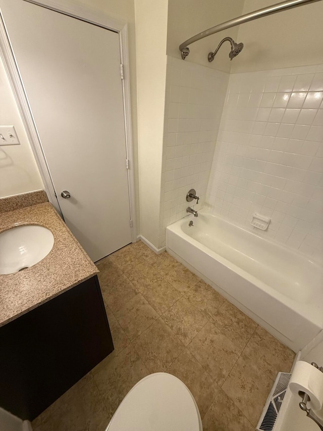 full bathroom with toilet, vanity, and tiled shower / bath