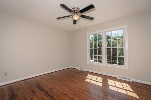 spare room featuring ceiling fan and dark hardwood / wood-style flooring