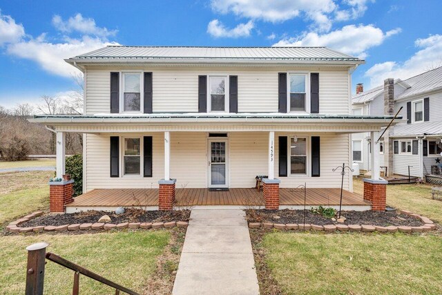 view of front of property with a porch and a front lawn