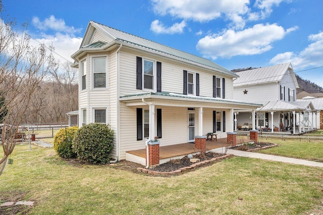 view of front of house featuring covered porch and a front lawn